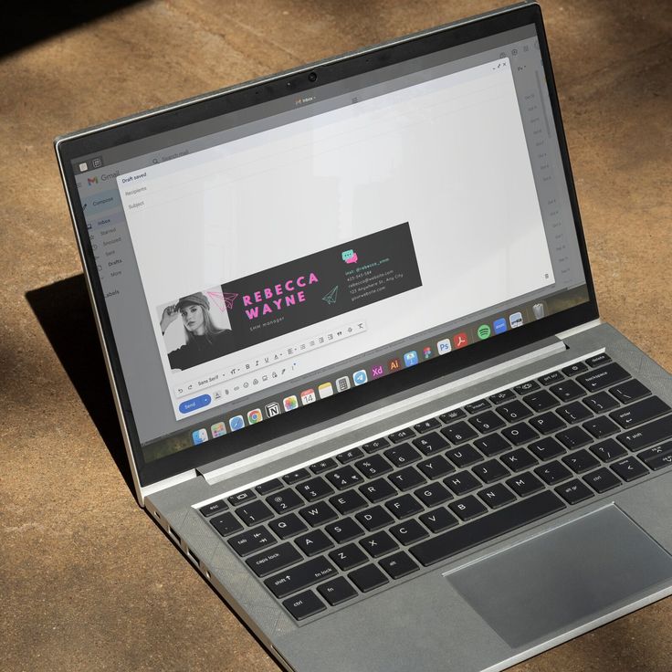 an open laptop computer sitting on top of a wooden table next to a cup of coffee