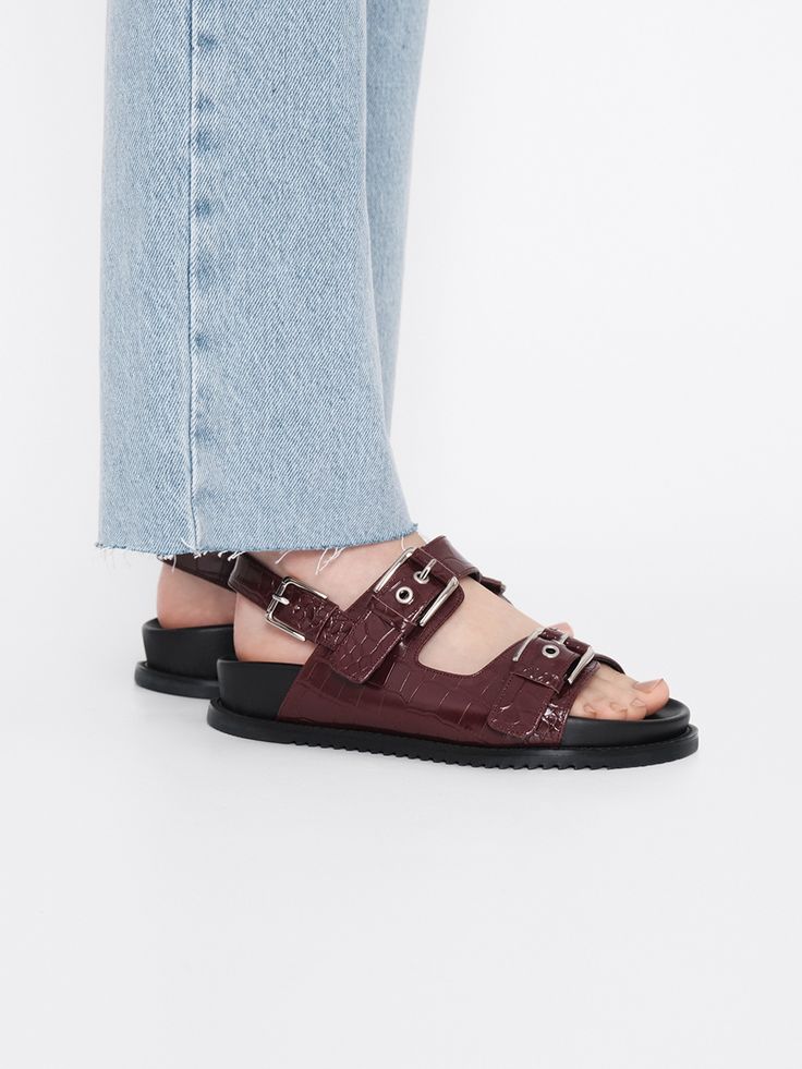 Editor's NotesRareness' shoes are designed for comfortable and basic styles.- Bold buckled double strap sandals- Cushioned sole bottom- Subtle glossy leather- Easy slide-in design- Modern almond toe shapeMeasurements(in.)- Size: KR 225MM (US 5.5) ~ KR 250MM (US 8)- Heel Height: 1.2 in.*Fits true to size.Composition & Care- Calf Leather- Lining: Pigskin Leather- Insole: Kidskin Leather- Avoid direct heat and moisture- Professional cleaning is recommendedDesigner- by rareness Summer Patent Leather Open Toe Slides, Double Strap Footbed Sandals With Heel Strap, Summer Open Toe Patent Leather Slides, Flat Patent Leather Sandals With Removable Insole, Modern Patent Leather Sandals With Buckle Closure, Leather Double Strap Slingback Sandals With Textured Footbed, Open Toe Patent Leather Slingback Sandals With Buckle Closure, Patent Leather Open Toe Slingback Sandals With Buckle, Patent Leather Slingback Sandals With Buckle Closure