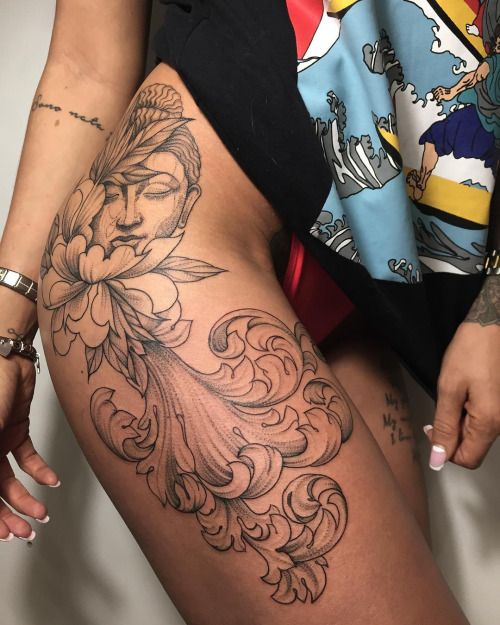 a woman's thigh with tattoos on it