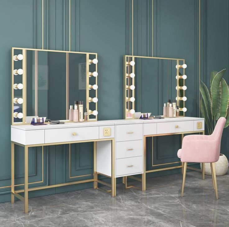 a dressing table with two mirrors and a pink chair