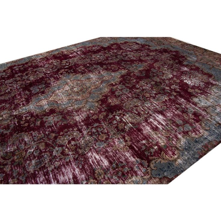 an area rug with red and blue colors on the bottom, in front of a white background