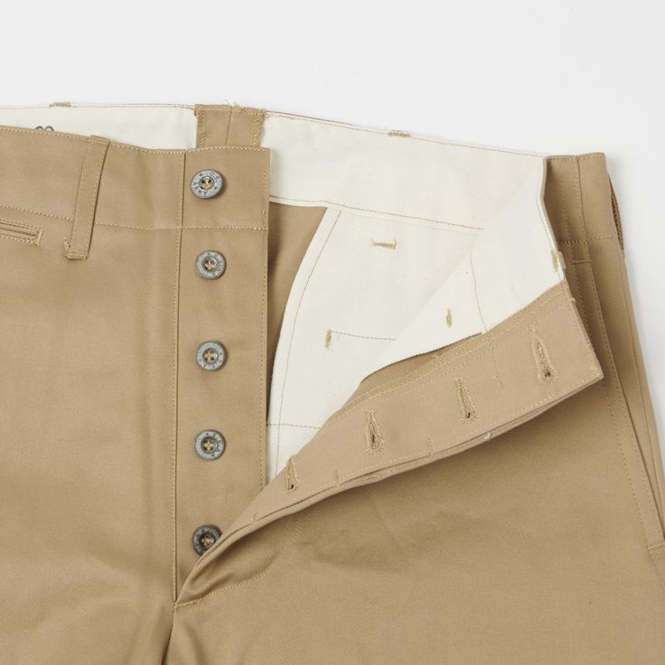 This 1945 military chino from Japan’s Buzz Rickson’s is cut from a neatly woven 100% cotton, and is cut in a vintage loose/straight shape. With a high rise and plenty of length to play around with, this trouser is as comfortable as you would expect it to be. The generous leg opening allows for great freedom of movement, and breathability, while traditional trouser details add an element of formality. Classic side entry pockets are present on the front, while a hidden watch pocket, and welted bac Trousers Details, Cotton Chinos, Freedom Of Movement, Sewing Lessons, Fashion History, Khaki Pants, Womens Bottoms, Vintage Inspired, China