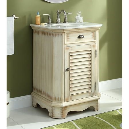 a bathroom vanity with shutters on the door and a round mirror above it, in front of a green wall