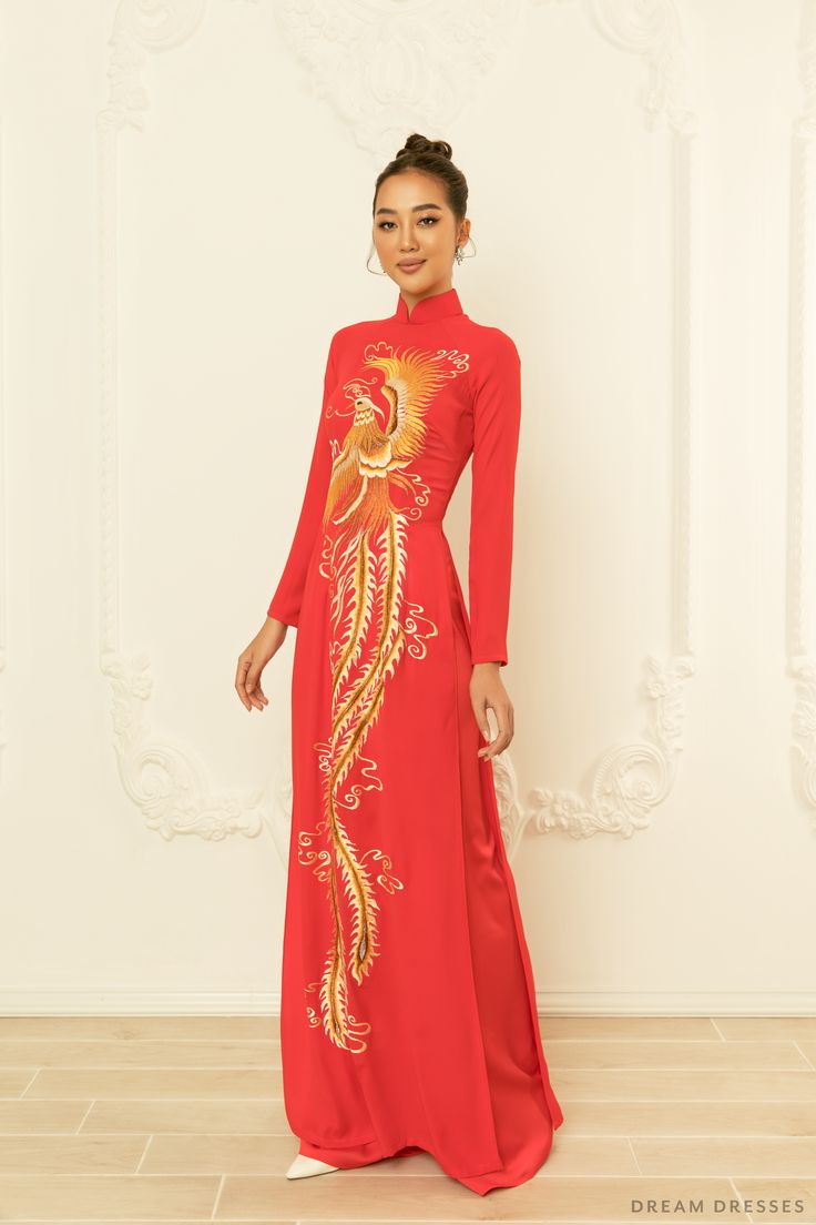 Make a bold, royal statement adorned in our Yedda red bridal ao dai with phoenix embroidery. There's no better combination than red and gold; you will look and feel like royalty adorned in this piece. A gorgeous custom embroidery phoenix features intricate, dainty details that are simple mesmerizing. Detail: Traditional Vietnamese Red Ao Dai Custom embroidery Phoenix Collar: 1.8in/ 4.5cm Long sleeves Zipper closure Red pants Made to order Traditional Red Ao Dai For Ceremony, Red Fitted Ao Dai For Traditional Ceremonies, Ceremonial Fitted Embroidered Ao Dai, Red Embroidered Ao Dai For Festive Occasions, Red Dress With Gold Embroidery For Traditional Ceremonies, Embroidered Ao Dai For Traditional Ceremonies, Festive Red Embroidered Ao Dai, Red Dress With Gold Embroidery For Festive Season, Red Ao Dai For Ceremony