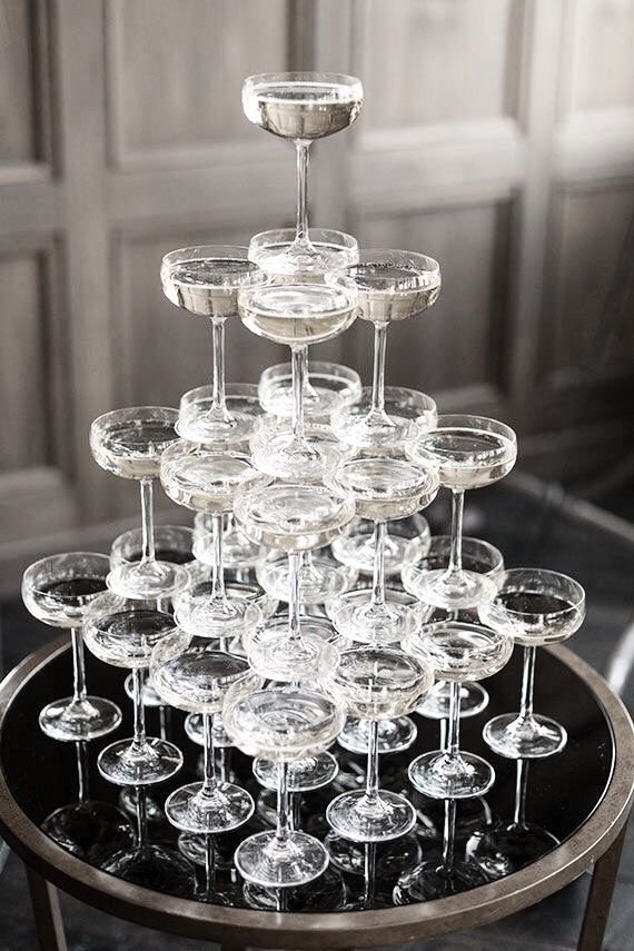 there are many wine glasses stacked on top of each other