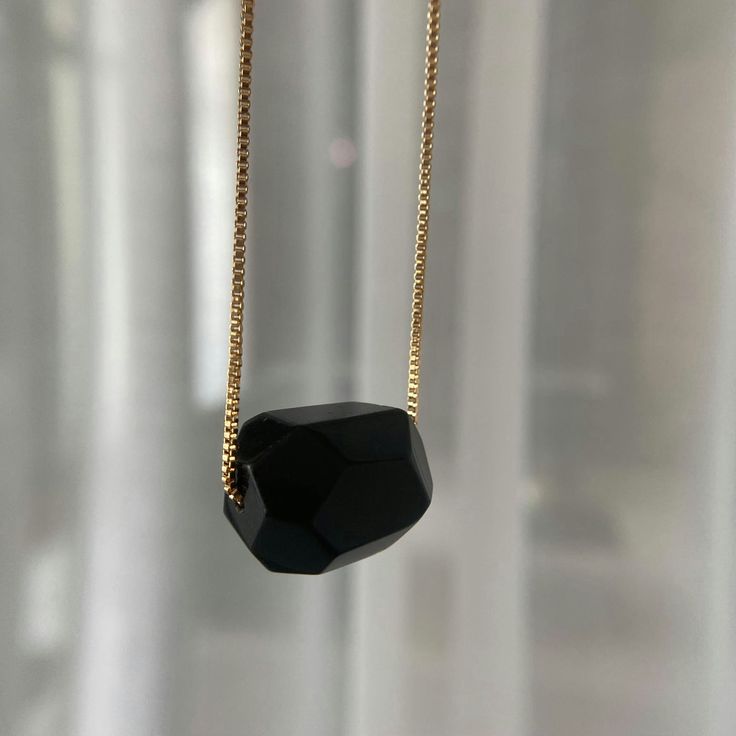 Made with beautiful black obsidian gemstone, this necklace is not only stylish but also has a meaning. Obsidian is known as a stone of protection, helping to shield you from negativity. It's also said to promote strength and courage, two qualities that we could all use more of in our lives. So not only will you look great wearing this black obsidian necklace, but you'll also feel great knowing that you're wearing something with such positive energy. Whether you're treating yourself or someone else, Black Obsidian Necklace makes for a perfect gift.

 	Size: 18 inches
 	Free Shipping 2 Days
 	Authentic Stone Black Obsidian Black Spiritual Crystal Necklace, Black Spiritual Crystal Necklaces, Spiritual Black Beaded Crystal Necklace, Black Onyx Crystal Necklace With Black Beads, Black Onyx Crystal Necklace With Natural Stones, Black Faceted Jewelry As A Gift, Black Faceted Jewelry For Gift, Black Necklace With Adjustable Chain For Gift, Black Spiritual Crystal Necklace With Gemstone