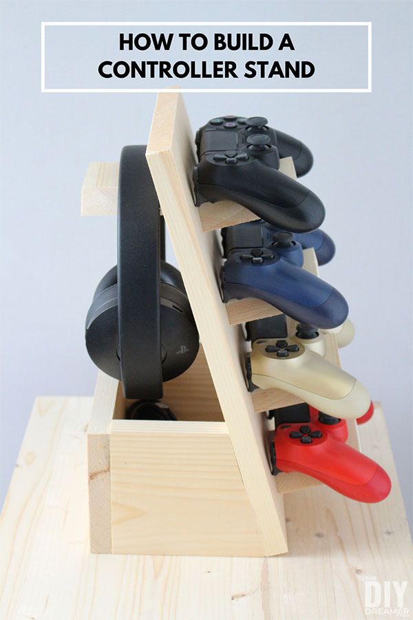 a wooden stand with video game controllers in it and text overlay that reads how to build a controller stand