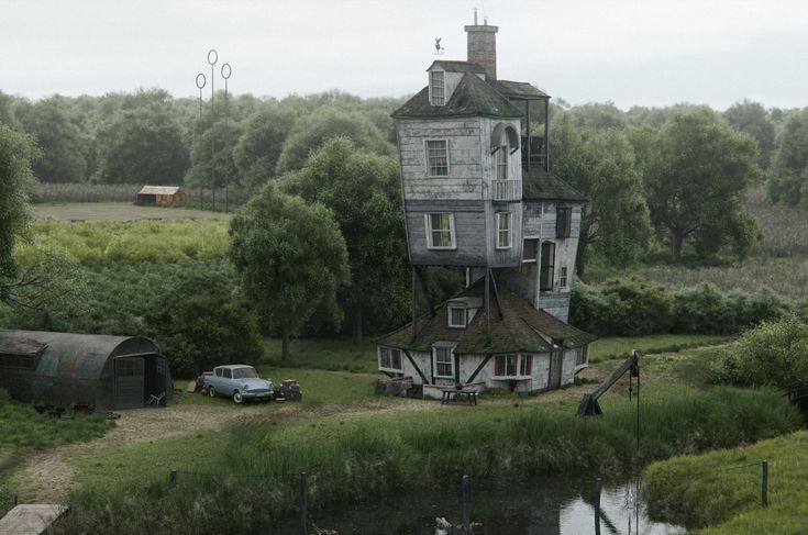 an old house sitting on top of a lush green field next to a lake and forest