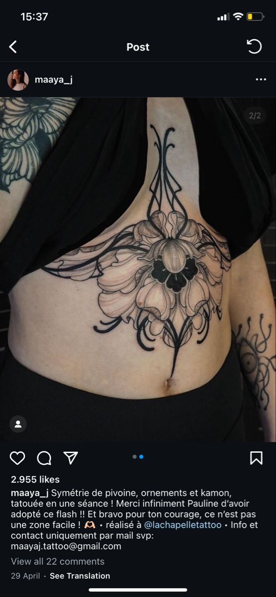 a woman's stomach with tattoos on it and the bottom half of her stomach