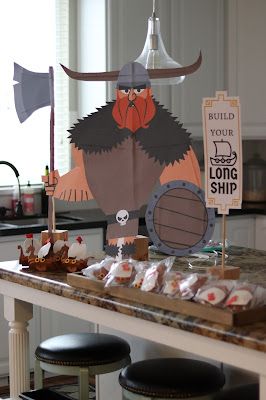 an image of a kitchen setting with food on the counter and decorations in the background