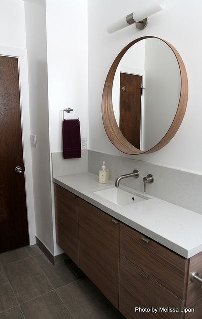 a bathroom with a sink and mirror in it