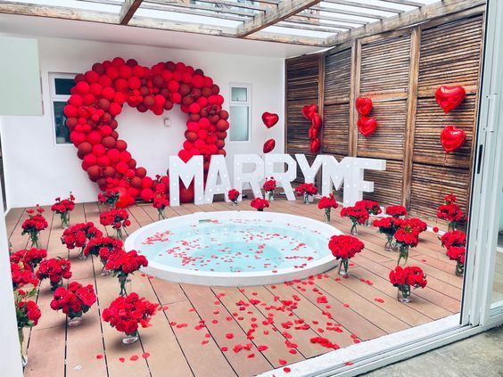 red flowers are in vases next to a sign that says i love marry