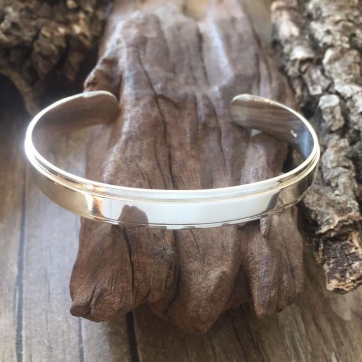 Our chunky silver men's cuff bangle is a perfect gift for birthdays and special occasions. They can be engraved - charges will depend on the number of letters required - please feel free to message me with the engraving you would like so that I can give you the price of the engraving. Modern White Gold Cuff Bracelet As Gift, White Gold Cuff Bracelet Gift, Engraved Cuff Bracelet For Anniversary, Gift White Gold Cuff Bracelet, Anniversary Engraved Cuff Bracelet, White Gold Cuff Bracelet For Gift, Classic Stamped Cuff Bracelets, Classic Stamped Cuff Bracelet, Classic Engraved Cuff Bangle