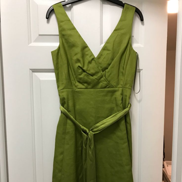 Olive-Lime Green Cotton Dress. V-Neck In Front And Back. Satin Tie Around Waist. Hits Around The Knee. Never Worn. Tags Still On. Green V-neck Midi Dress For Cocktail, Green V-neck Cocktail Dress, Green Surplice Neckline Dress For Work, Green V-neck Dress For Brunch, Green V-neck Dress For Spring Workwear, Green V-neck Lined Mini Dress, Summer Cocktail Dress With Notched Neckline, Green Lined V-neck Dress, Green Cotton Dress