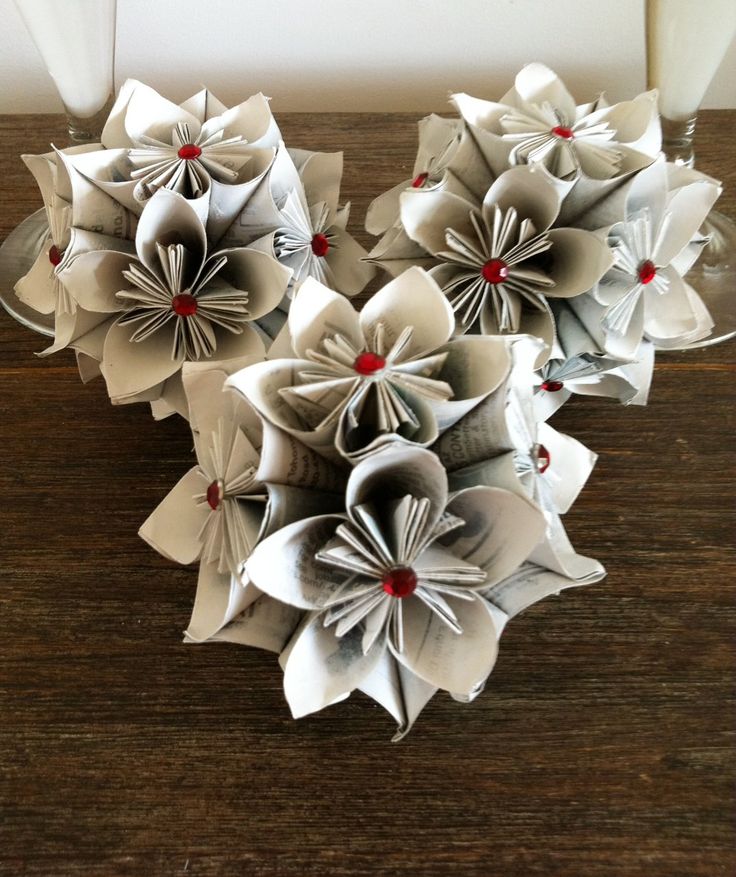 three paper flowers are sitting on a table