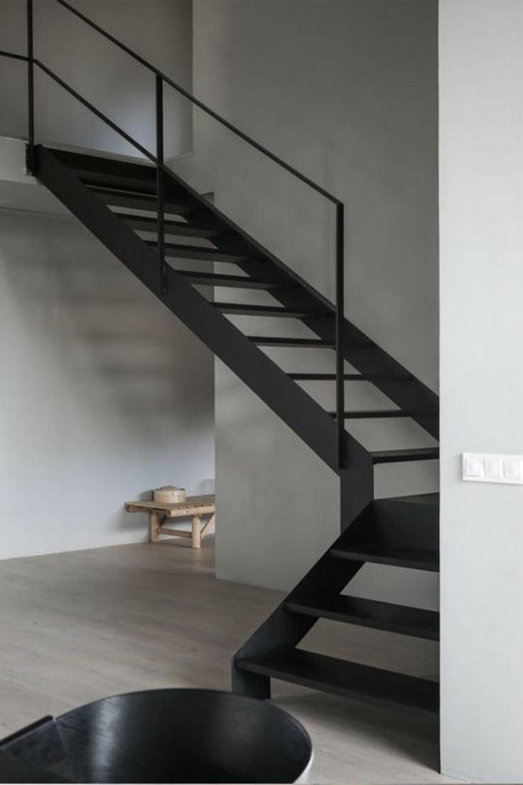 a black and white staircase in an empty room