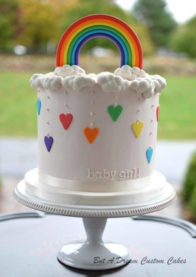 a white cake with rainbow decorations on it