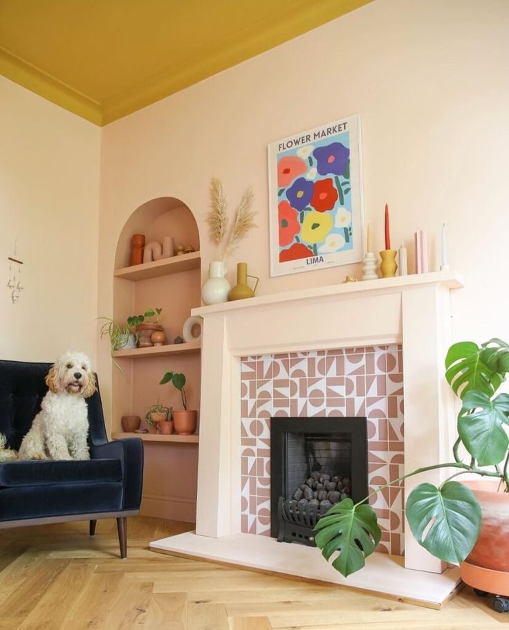 a living room with a fireplace, potted plants and a dog sitting on the chair