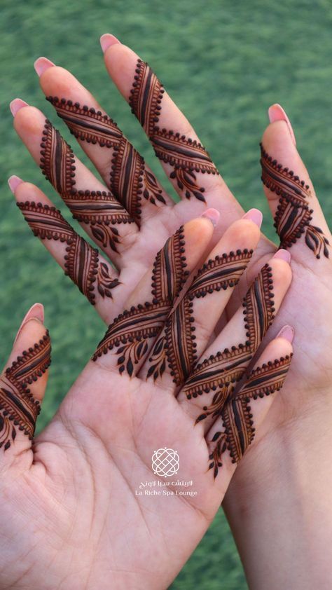 two hands with hendi designs on them