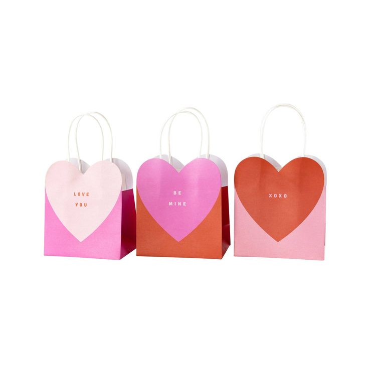 three paper bags with hearts on them, one pink and one orange are in the shape of heart