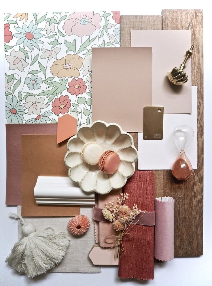 various items are arranged on top of each other, including paper and flowers in the background