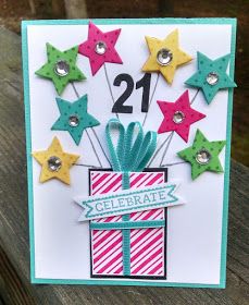 a handmade 21st birthday card with stars on it and a present in the middle