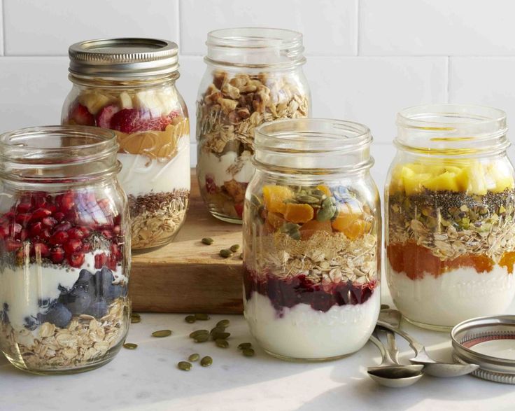 jars filled with granola, yogurt and fruit