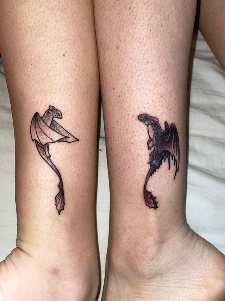 two people with matching tattoos on their legs, one has a bird and the other has a fish