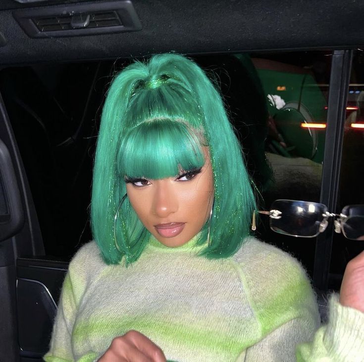 a woman with green hair in a car