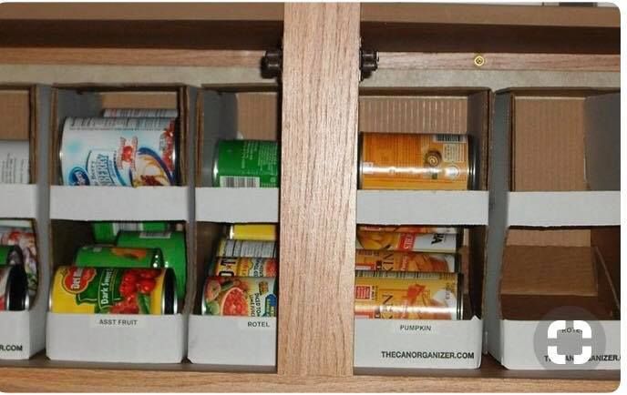 an organized pantry with canned food and snacks in it's bins on the shelf