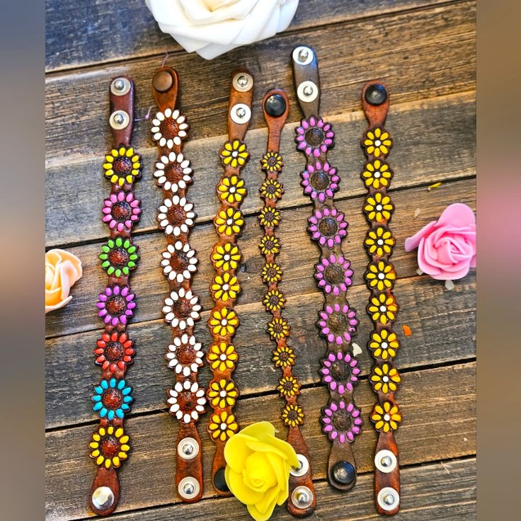 several different bracelets with flowers on them