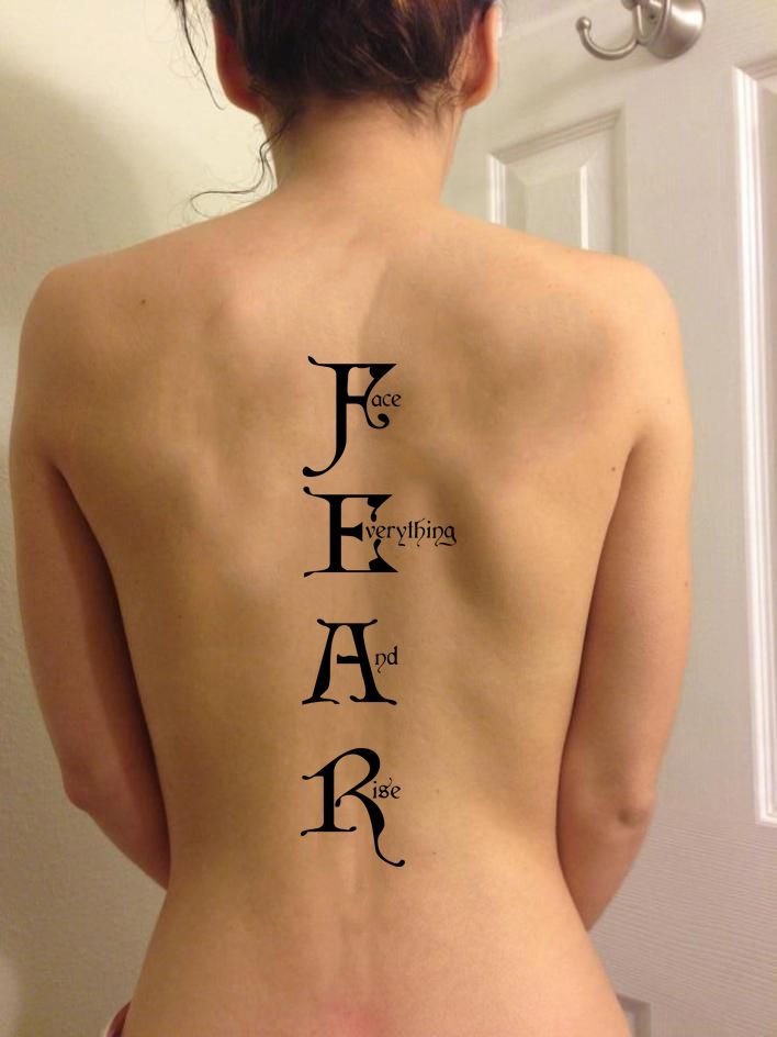 the back of a woman's body with words on it that spell out her name