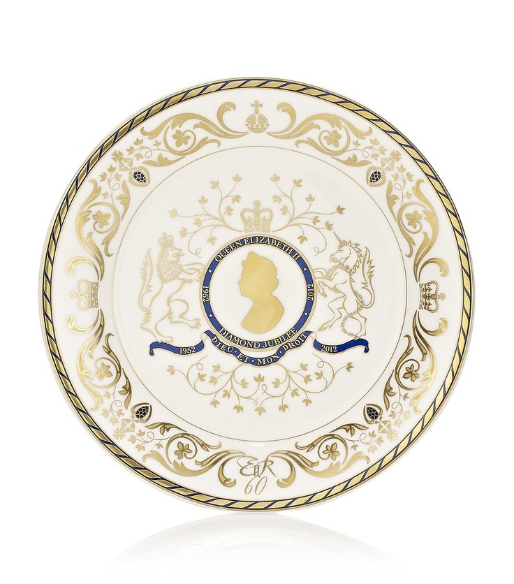 a white and gold plate with an image of a woman's head on it