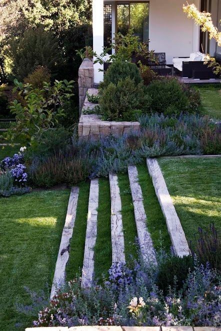 an outdoor garden with steps leading up to the house