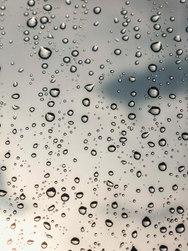 drops of water on the window with sky in background