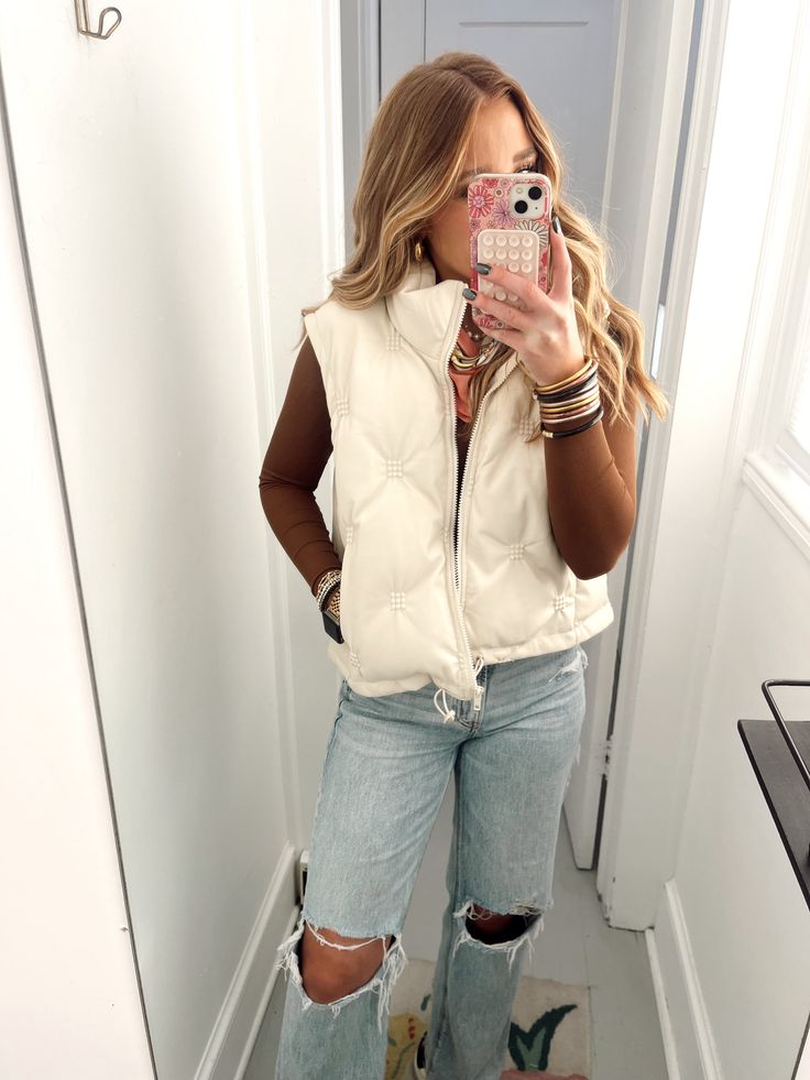 The most perfect pleather puffer vest!! This is a beige colored vest that has some embellishments on it!! This is the perfect elevated vest, easy to layer and easy to dress up or just to throw on over a sweatshirt!!! This is a true to size fit with a great length!! Long Sleeve With Puffer Vest, Cute Winter Outfits With Vest, Off White Vest Outfit, Ivory Puffer Vest Outfit, Women’s Puffer Vest Outfit, White Puffer Vest Outfits For Women, Tan Puffer Vest Outfit, Cream Puffer Vest Outfit, White Vest Outfits For Women