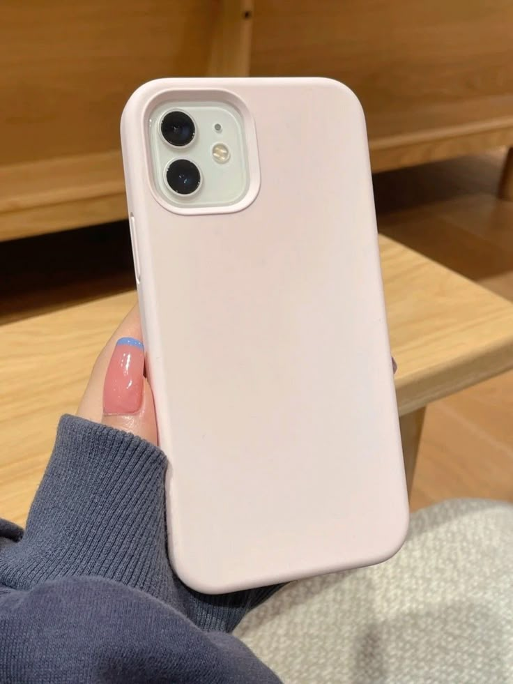 a person holding an iphone case in their hand