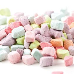 a pile of pink and green marshmallows on a white background with the words deliciousness bulk foods