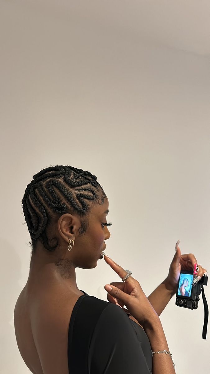 black woman with a unique cornrow hairstyle holding a digital camera Heart Shaped Cornrows, Cornrow Freestyle, Cornwors Hairstyle Black Women, Unique Cornrow Hairstyles, Cool Cornrows, Unique Cornrows, Cross Cornrows, Cornrow Hairstyle, Unique Braids