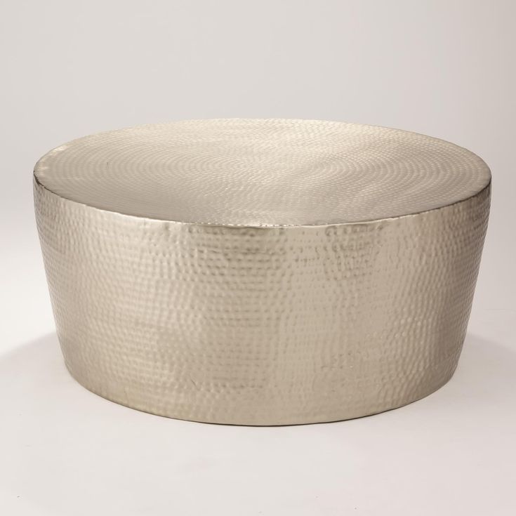 a large metal bowl sitting on top of a white table