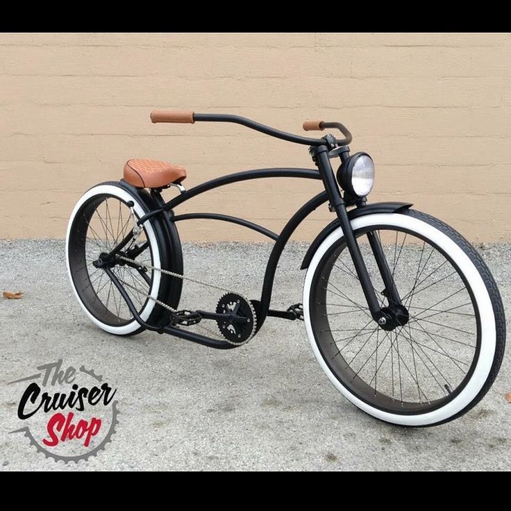 an old fashioned bicycle is parked in front of a wall