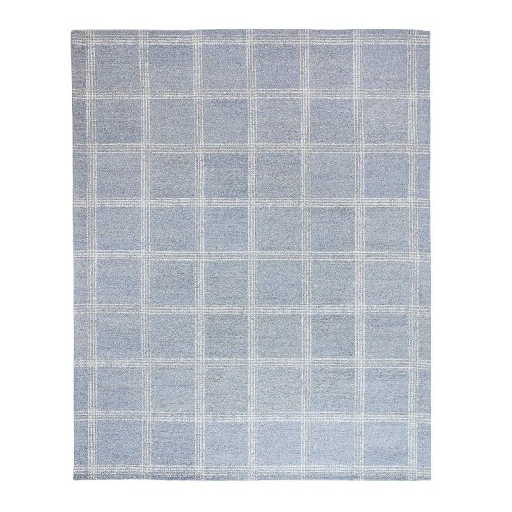 a light blue and white rug with squares on the bottom, in front of a white background