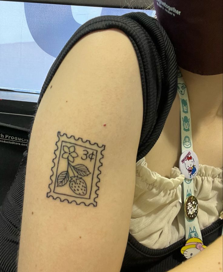 a woman's arm with a stamp on it that has a flower in the middle