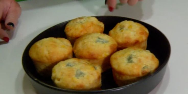 a bowl filled with muffins sitting on top of a table