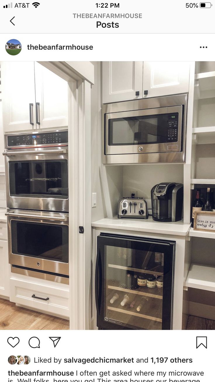 two ovens are built into the wall in this kitchen with white cabinets and stainless steel appliances