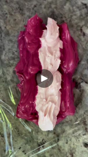 a piece of red and pink cake sitting on top of a counter