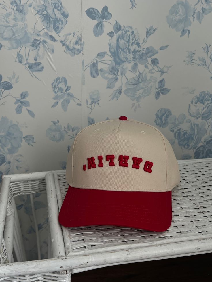 The RA Darlin' Trucker is a modern take on the classic trucker hat. Designed after Rylee's iconic red darlin tattoo and the popular upside down Dallas hat worn by Post Malone, this hat is sure to turn heads. The high-quality puff embroidery adds a special touch, ensuring durability for a lifetime of wear. Perfect for those looking for a unique and stylish accessory. Red Retro Trucker Hat With Short Brim, Retro Snapback Hat With Curved Brim, Retro Snapback Fitted Hat, Retro Snapback Cap, Retro Snapback Hat, Retro Flat Brim Hat With Letter Print, Retro One Size Fits Most Snapback Hat, Trendy Red Trucker Hat With Short Brim, Retro Flat Brim Trucker Hat For Baseball Season