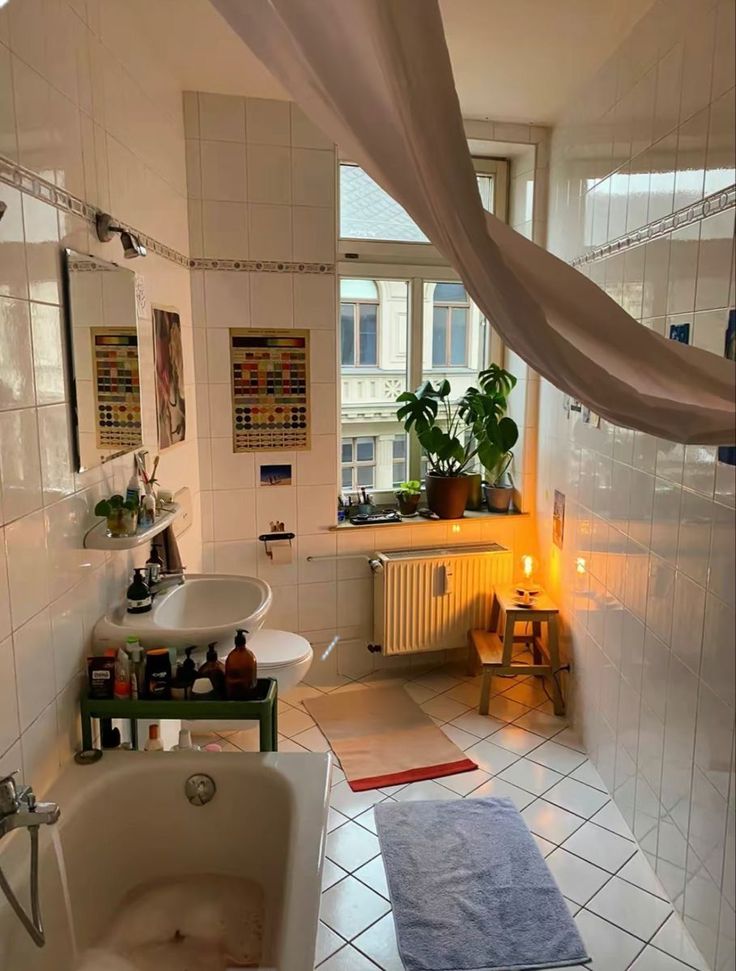 a bath room with a tub a sink and a window