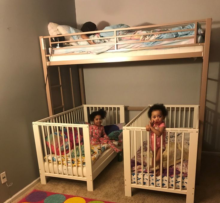 two children are sitting in their bunk beds, one on the floor and one on the ground