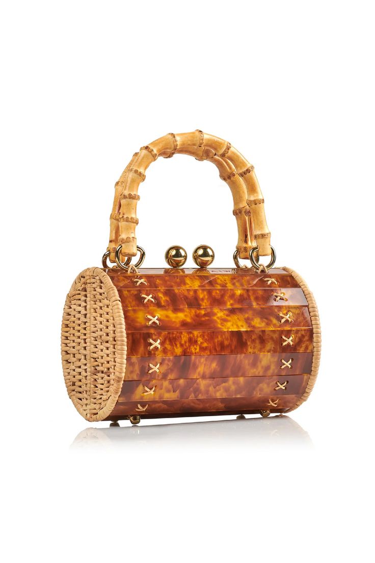 Meet the Alix Bambu Turtle Bag, a versatile and stylish addition to your accessory collection. Featuring a charming bamboo handle and a removable leather shoulder strap, this bag seamlessly transforms from a shoulder bag to a crossbody or handbag. It is a unique blend of handwoven, natural rattan and modern acrylic, which creates a playful yet sophisticated look. Perfect for any occasion, this bag is your go-to for effortless style and functionality. Luxury Brown Bag With Bamboo Handle, Luxury Brown Bags With Bamboo Handle, Luxury Crossbody Bag With Bamboo Handle, Luxury Rectangular Shoulder Bag With Bamboo Handle, Brown Crossbody Shoulder Bag With Bamboo Handle, Luxury Satchel Shoulder Bag With Bamboo Handle, Rectangular Straw Bag With Bamboo Handle For Evening, Crossbody Bucket Bag With Bamboo Handle, Evening Rectangular Straw Bag With Bamboo Handle